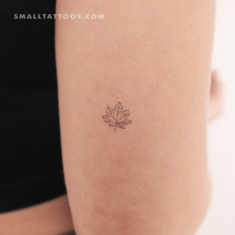 Single needle maple leaf tattoo located on the inner